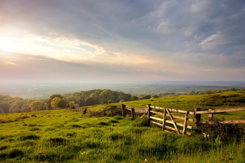 Green hills in rural England with a blue sky above